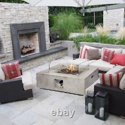 Table de chauffage extérieur en béton pour foyer au gaz dans le jardin, avec verre, roches de lave et housse.